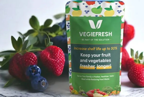 VeggieFresh produce saver bag with fresh strawberries, blueberries and greens on a marble surface